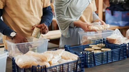 Volunteers packing food donation items 